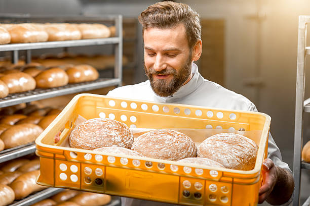 istock Baker holding breads at the manufacturing 517058142