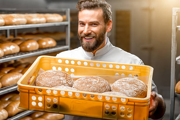 istock Baker holding breads at the manufacturing 517058238