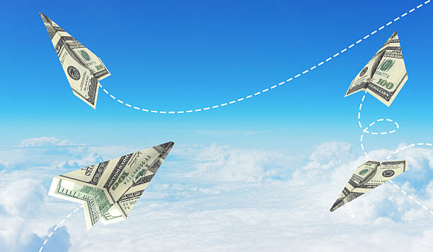 istock Paper airplanes made of hundred dollar bills 517058593