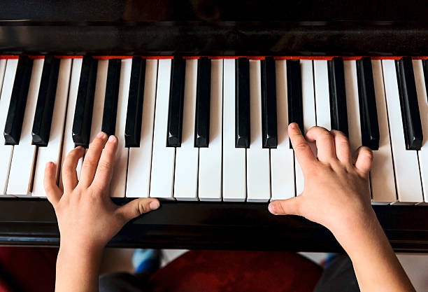 istock Child's hands playing the piano 517058630