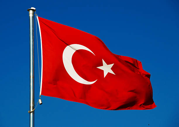 istock Turkish national flag over blue sky 517058993