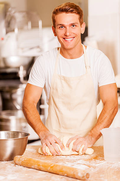 Baker kneading the dough.