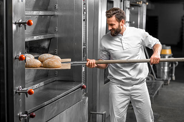 istock Baker taking out from the oven baked buckweat bread 517075182