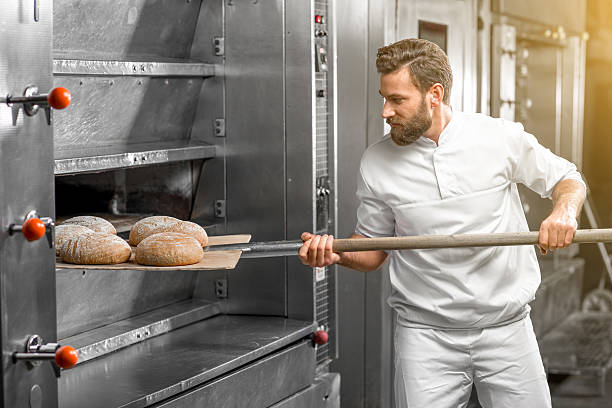 istock Baker taking out from the oven baked buckweat bread 517075282