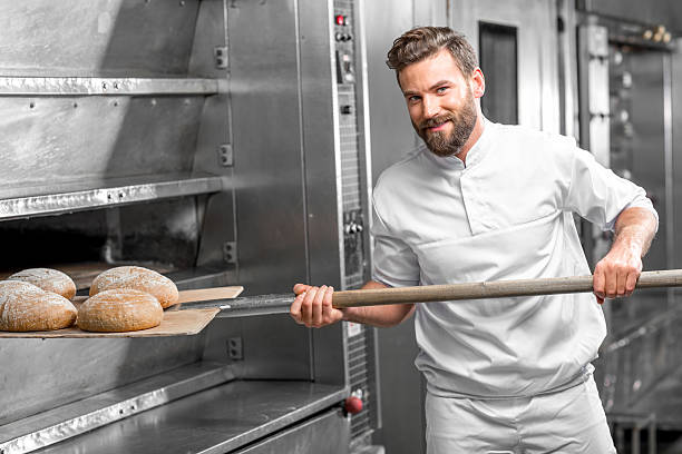 istock Baker taking out from the oven baked buckweat bread 517075354