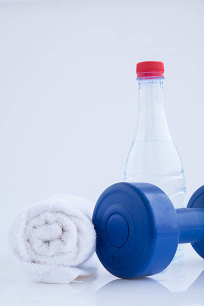 istock Blue plastic coated dumbells And Water Bottle isolated on white 517077379