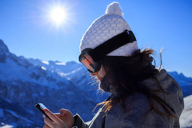 istock Snow skier young woman using a smartphone  Alps mountain 517077402