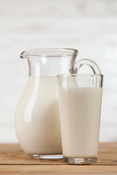 istock Milk jar on wooden table 517078814