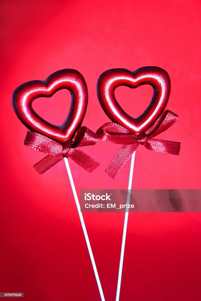 two red valentine hearts with bows against red background two red valentine hearts with bows against red background, valentines day card concept Abstract Stock Photo