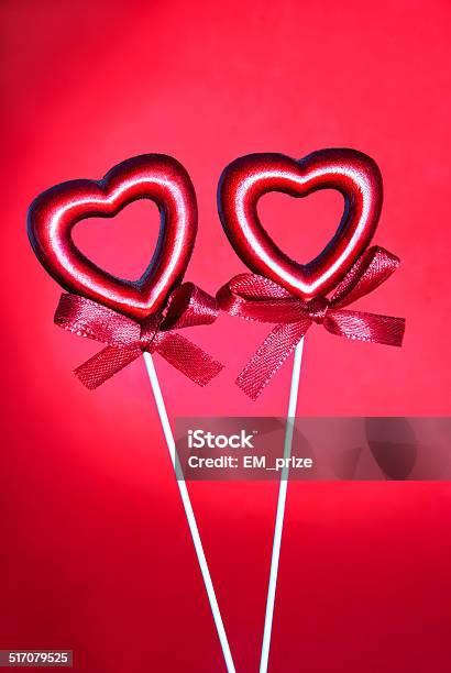 Two Red Valentine Hearts With Bows Against Red Background Stock Photo - Download Image Now