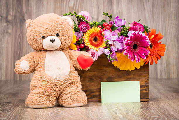 istock Bunch of flowers and a teddy bear 517081352