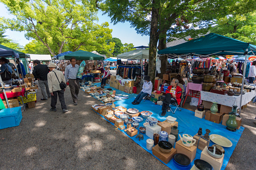 Kyoto, Japan - May 21, 2015: Crowds of people shopping at the Toji Temple markets held monthly on the 21st of the month in Kyoto, Japan
