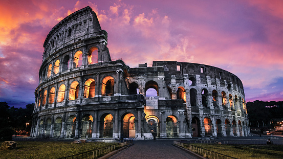 The Roman Colosseum stands guard against the fading day in the heart of ancient Rome, Italy.