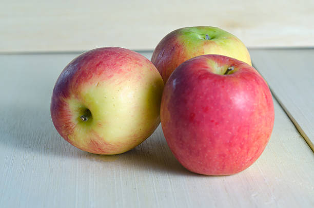 istock Apple isolated on wooden board background 517087526