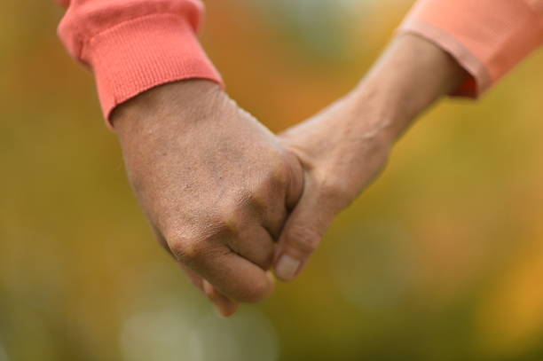 istock Elderly couple holding hands 517088756