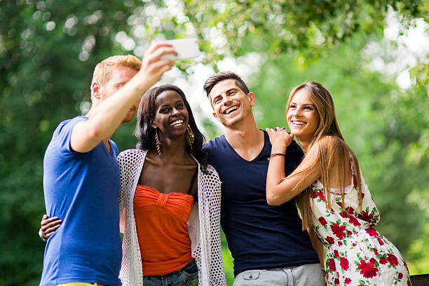 istock Group of young people and couples taking selfies in nature 517090012