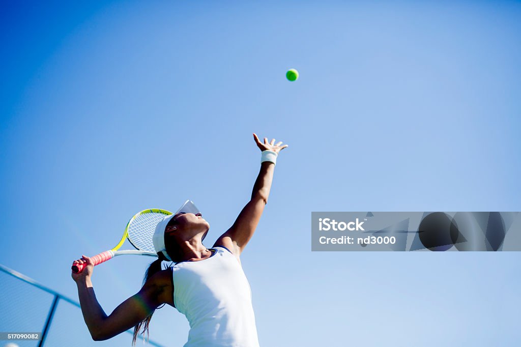 Beautiful female tennis player serving Beautiful female tennis player serving outdoor Tennis Stock Photo