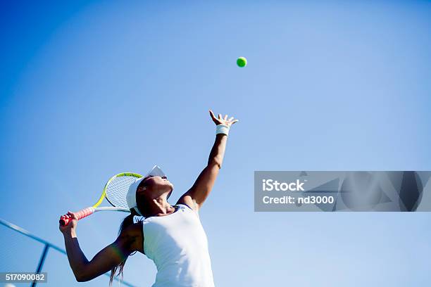 Beautiful Female Tennis Player Serving Stock Photo - Download Image Now - Tennis, Sport, Women