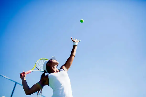 Photo of Beautiful female tennis player serving