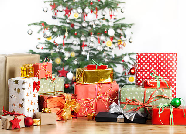 istock christmas tree with lots of gifts 517093669