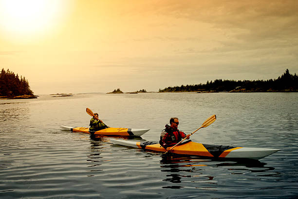 A senior couple kayaking in a lake.
