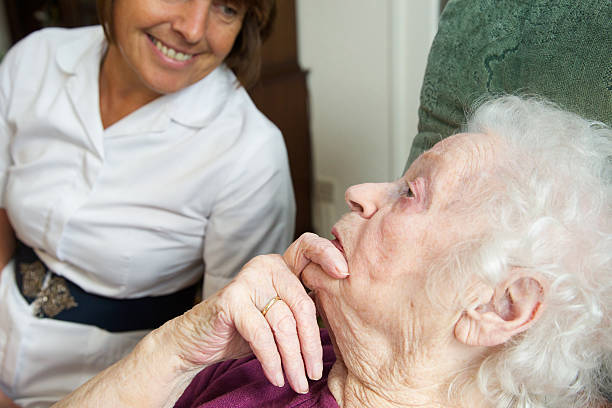 istock Care worker nurse caring for an elderly woman 517096797