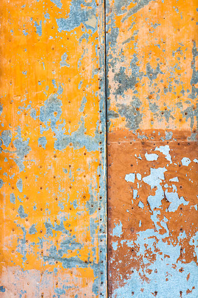 istock Abstract Orange and Grey Background: Weathered Peeling Metal Door 517097654