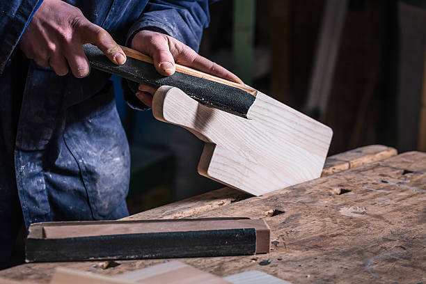 istock Carpenter sanding piece of Timber with sandpaper 517097790