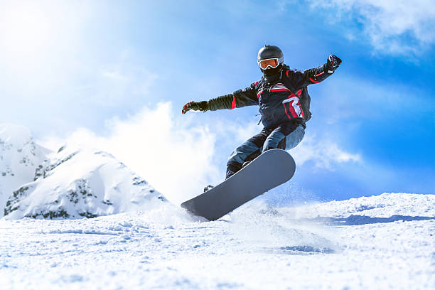 istock Jumping snowboarder from hill in winter 517098364