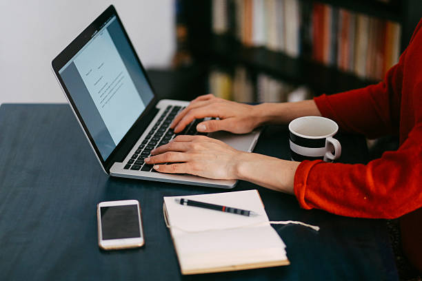 istock Woman freelancer or blogger typing on the laptop 517098536