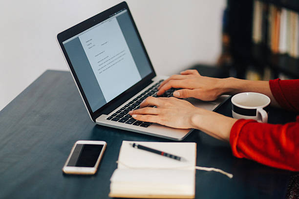 istock Woman freelancer or blogger typing on the laptop 517098678
