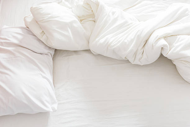 istock Top view of an unmade bed with a pillow, 517104052