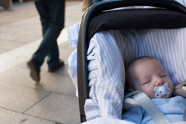 istock baby boy  sleeping in his stroller a sunny day 517104782