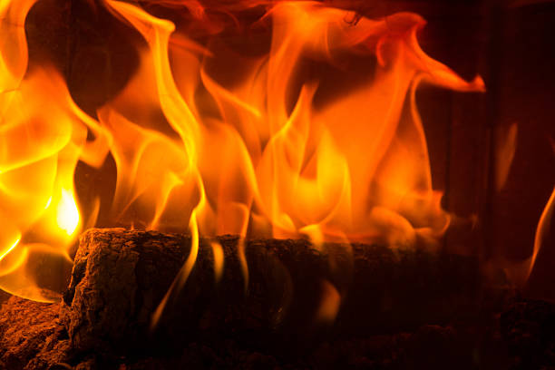 istock Log on fire burning billets in fireplace 517107134