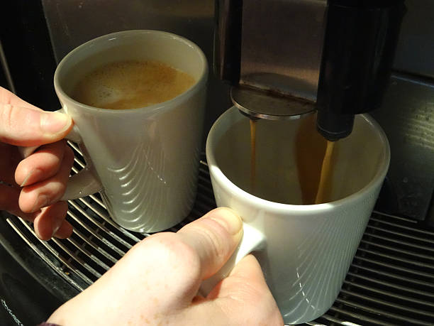 istock Image of frothy cappuccinos made in a self-service coffee machine 517109236