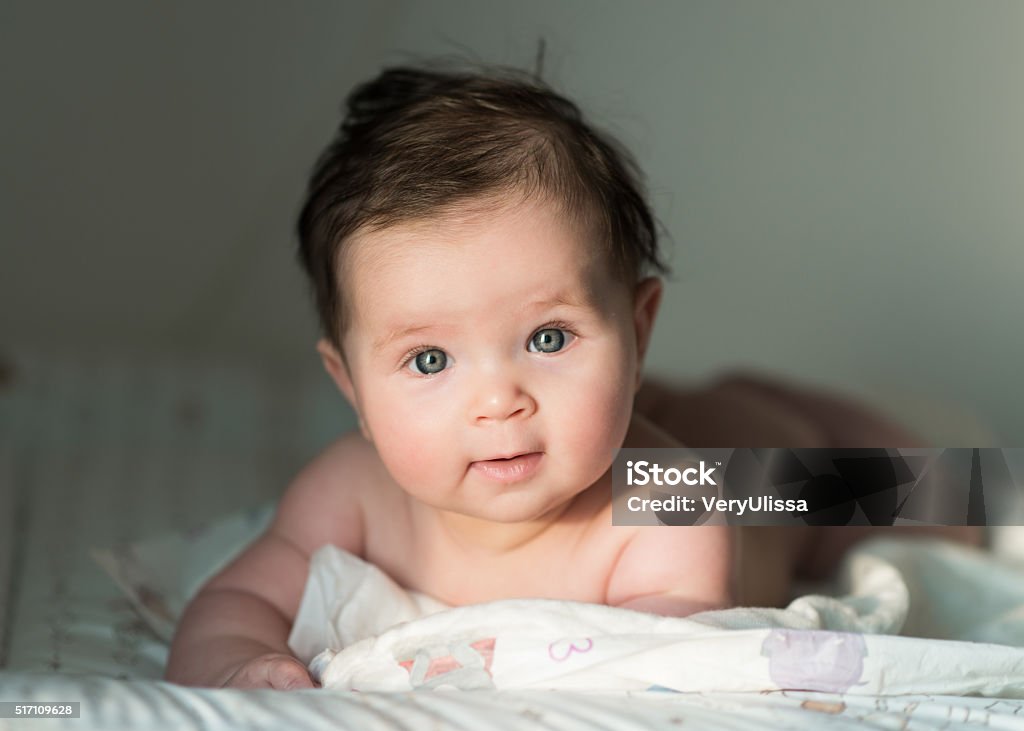 cute baby with dark hair cute baby with dark hair lying Baby - Human Age Stock Photo