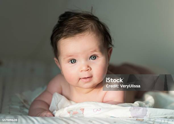 Cute Baby With Dark Hair Stock Photo - Download Image Now - Baby - Human Age, Backgrounds, Bed - Furniture