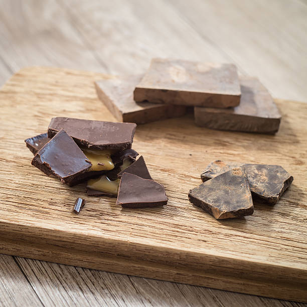 istock Dark chocolate with cocoa on wooden board 517109788