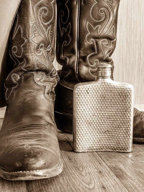 istock Sepia Cowboy Boots and Flask 517111644
