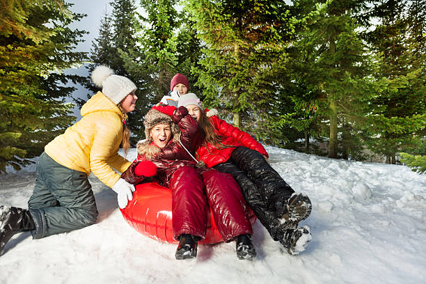 istock Group of kids riding down hill on red ice-boat 517120852