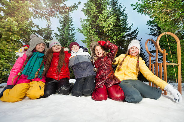 istock Five kids playing in the snow at wintertime 517121636
