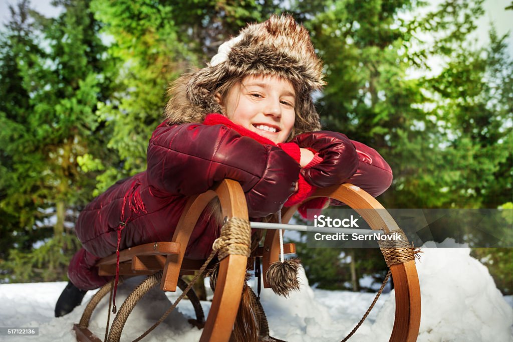 Niña sonriente divirtiéndose en invierno, nieve, en trineo - Foto de stock de Abeto Picea libre de derechos