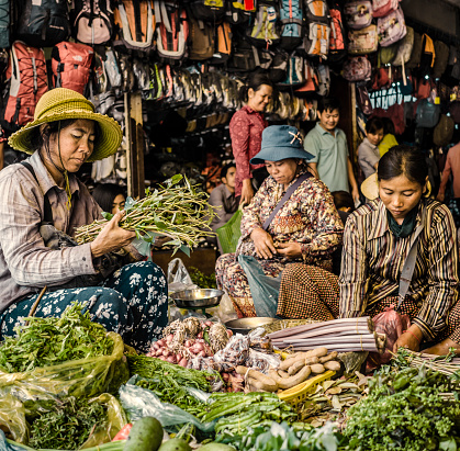 Siem Reap, Сambodia - February 25, 2016: Vendors selling their products at the daily food market located in the old market in Siem reap Cambodia. Psah Chas the name of the market is very popular among locals and tourists. It sells all king of goods from souvenirs to fresh food