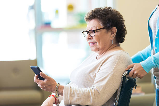 istock Senior woman using smart phone in nursing home 517122836