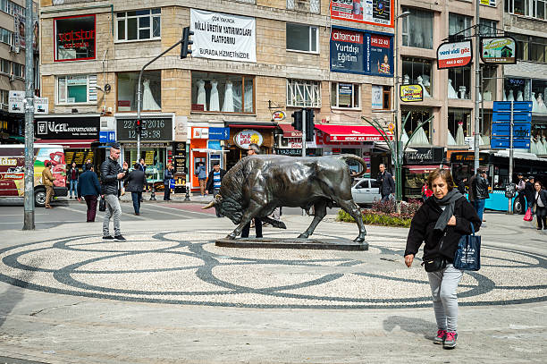 Istanbul, Turkey - March 22, 2016: People are passing by bull statue in the Kadikoy. Bull is the symbol of this district.