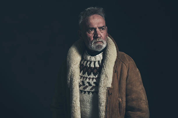 istock Senior man wearing knitted sweater and lambs wool coat. 517125060