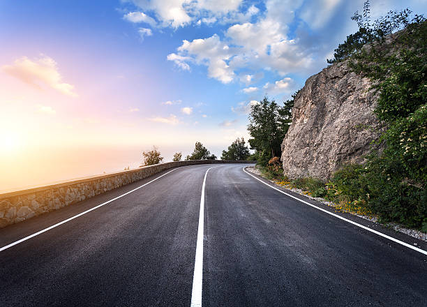 istock Beautiful mountain asphalt road with rocks, blue sky at sunset 517126114