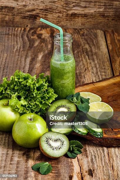 The Bottles With Fresh Vegetable Juices On Wooden Table Stock Photo - Download Image Now