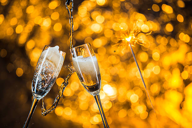 istock New Year's at midnight with champagne glasses on light background 517127310