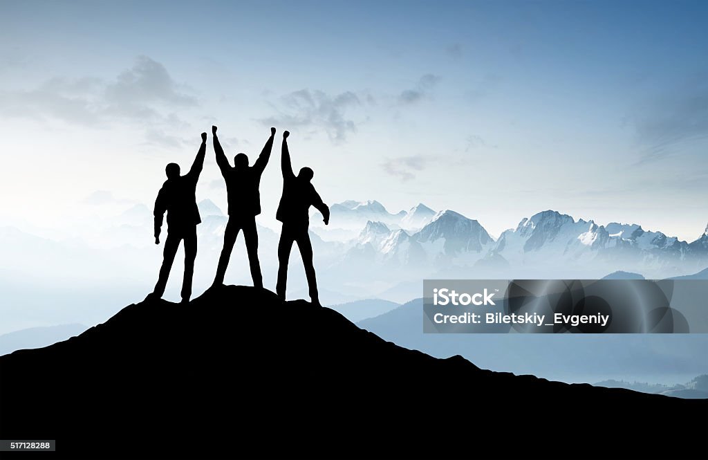 Silhouettes of a team Silhouettes of a team on mountain peak. Sport and active life concept Mountain Peak Stock Photo